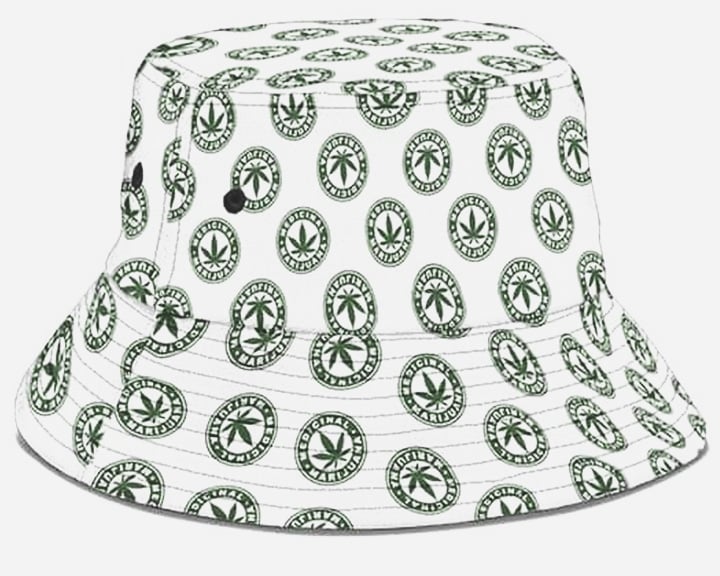 Een witte bucket hat met een patroon van groene marihuanabladeren.