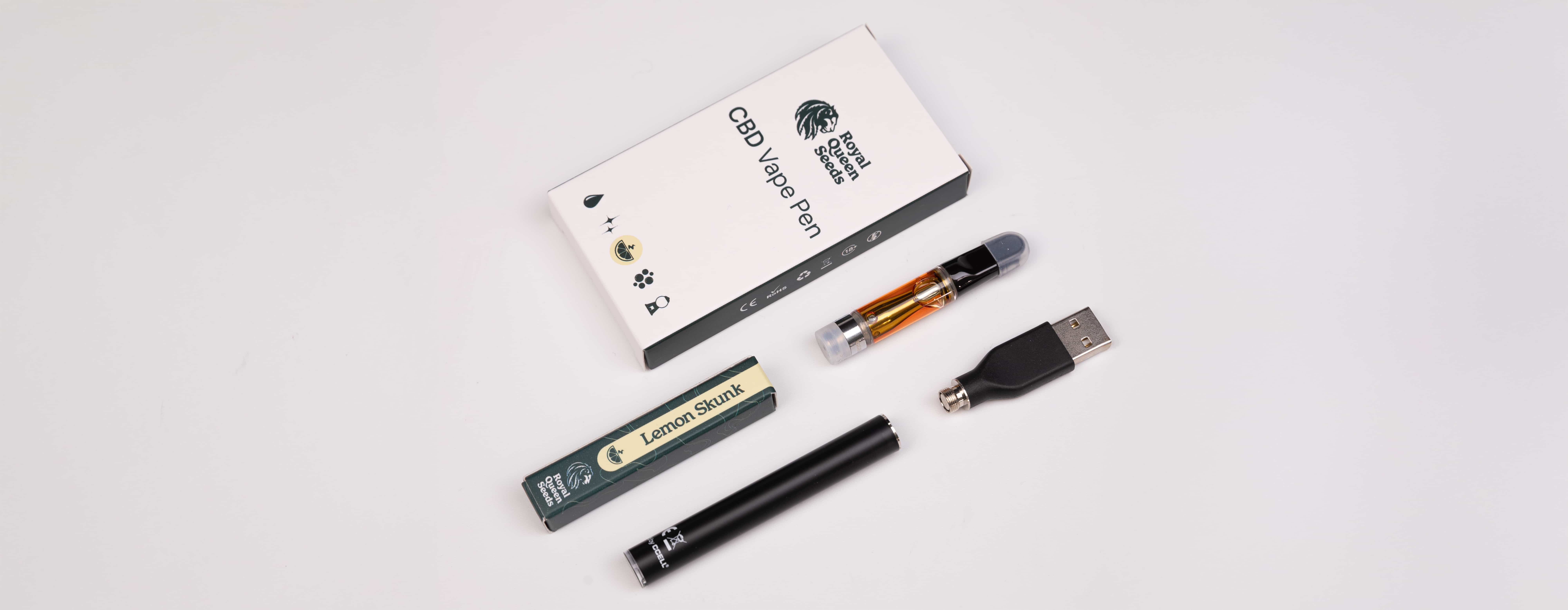 Een zwarte doos met een wit etiket met de tekst vape kit en royal gorilla de doos is open bevat een vape-pen cartridge usb-oplader